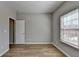 This bedroom has hardwood floors, a large window and a door to the exterior at 68 Hardy Water Dr, Lawrenceville, GA 30045