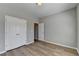 This bedroom features a large double-door closet, neutral colored walls, and hardwood flooring at 68 Hardy Water Dr, Lawrenceville, GA 30045