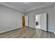 A large bedroom featuring hardwood floors, recessed lights, and a view into the bathroom at 68 Hardy Water Dr, Lawrenceville, GA 30045