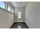 Bright entryway featuring hardwood floors, neutral paint and a door with glass and blinds at 68 Hardy Water Dr, Lawrenceville, GA 30045