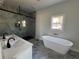 Bright bathroom featuring a soaking tub, shower, and dual sink vanity at 1510 Olympian Sw Way, Atlanta, GA 30310