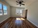 Bright bedroom featuring hardwood floors, a ceiling fan, and large windows providing natural light at 1510 Olympian Sw Way, Atlanta, GA 30310