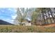Backyard with gazebo, lush trees, and grassy lawn at 3897 Vine Stone Dr, Stonecrest, GA 30038