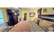 Large bedroom with bed, dresser, and door into bathroom and staircase at 3897 Vine Stone Dr, Stonecrest, GA 30038