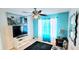 Comfortable bedroom featuring a ceiling fan, TV, modern decor, and a vibrant blue accent wall at 3897 Vine Stone Dr, Stonecrest, GA 30038