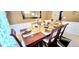 The dining room displays a large table set with decorative accents for elegant dining at 3897 Vine Stone Dr, Stonecrest, GA 30038