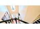 View from staircase of bright two-story foyer with chandelier and large artwork at 3897 Vine Stone Dr, Stonecrest, GA 30038