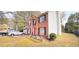 Charming brick two-story home with black shutters, two-car garage and lush lawn at 3897 Vine Stone Dr, Stonecrest, GA 30038