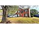 Charming brick two-story home with manicured lawn and a bright red front door at 3897 Vine Stone Dr, Stonecrest, GA 30038