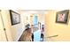 Hallway with wood floors, decorative artwork on the walls, and access to other rooms at 3897 Vine Stone Dr, Stonecrest, GA 30038
