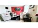 Inviting living room with soft armchairs, a unique coffee table, and a vivid red accent wall at 3897 Vine Stone Dr, Stonecrest, GA 30038