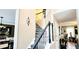 Elegant staircase with unique patterned treads, a decorative light fixture, and black handrails at 3897 Vine Stone Dr, Stonecrest, GA 30038