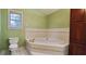 Large bathroom featuring a relaxing soaking tub and modern fixtures at 4473 Marjorie, Snellville, GA 30039