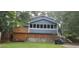 Back exterior showcasing blue siding, deck, and an elevated, screened-in porch for outdoor enjoyment at 4473 Marjorie, Snellville, GA 30039