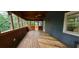View of spacious covered back porch with wood floors and ceiling fan, perfect for outdoor relaxation at 4473 Marjorie, Snellville, GA 30039