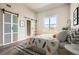 Bright bedroom featuring barn doors, wood floors, and a light-filled window with a city view at 502 Pryor Sw St # 301, Atlanta, GA 30312