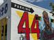 Exterior shot highlighting a parking sign and a mural depicting Hank Aaron on a white brick building at 502 Pryor Sw St # 301, Atlanta, GA 30312