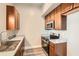 Galley style kitchen featuring stainless steel appliances, neutral countertops, and wood cabinets at 502 Pryor Sw St # 301, Atlanta, GA 30312