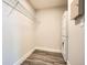 Bright laundry room featuring a stacked washer and dryer unit, wire shelving and hardwood floors at 502 Pryor Sw St # 301, Atlanta, GA 30312