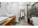 This bathroom features dual sinks, a glass shower, and a modern freestanding soaking tub at 2870 Pharr Ct # 3002, Atlanta, GA 30305