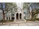 Exterior view of the building entrance with lush trees and accessible ramps and stairs at 2870 Pharr Ct # 3002, Atlanta, GA 30305