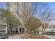 The building exterior is framed by mature trees and a circular driveway at 2870 Pharr Ct # 3002, Atlanta, GA 30305