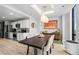 This dining room features a modern light fixture, an accent painting, and hardwood floors at 2870 Pharr Ct # 3002, Atlanta, GA 30305