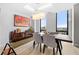 This dining room features floor-to-ceiling windows, a modern light fixture, and hardwood floors at 2870 Pharr Ct # 3002, Atlanta, GA 30305