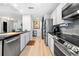 This kitchen features stainless steel appliances, white cabinets, and a stylish backsplash at 2870 Pharr Ct # 3002, Atlanta, GA 30305