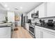 Modern kitchen featuring stainless steel appliances, white cabinets, and dark countertops at 2870 Pharr Ct # 3002, Atlanta, GA 30305