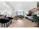 Spacious living room open to kitchen with barstool seating, large sofa, and TV at 2870 Pharr Ct # 3002, Atlanta, GA 30305
