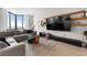 Modern living room with large windows, sofa, TV, and shelving at 2870 Pharr Ct # 3002, Atlanta, GA 30305