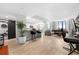 Bright, open-concept living room with a modern kitchen, breakfast bar, and floor-to-ceiling windows at 2870 Pharr Ct # 3002, Atlanta, GA 30305