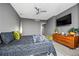 This primary bedroom is complete with a ceiling fan, a TV, and hardwood floors at 2870 Pharr Ct # 3002, Atlanta, GA 30305