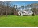 Expansive backyard featuring a lush lawn and established garden beds, offering a serene outdoor space at 329 Owens Store Rd, Canton, GA 30115