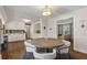 A dining area with a round table is attached to a kitchen with white cabinets and granite countertops at 329 Owens Store Rd, Canton, GA 30115