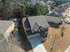 Aerial view of a two-story home with a spacious driveway and well-maintained lawn in a residential neighborhood at 6545 Muirfield Pt, Fairburn, GA 30213