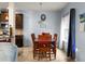 Dining area with a wooden table set with seating for four, near kitchen with modern fixtures at 6545 Muirfield Pt, Fairburn, GA 30213