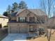 Charming two-story brick home with a two-car garage and a cozy front porch at 6545 Muirfield Pt, Fairburn, GA 30213