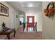 Second floor hallway with stairs, and a view into another room with natural light at 6545 Muirfield Pt, Fairburn, GA 30213
