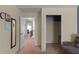 Hallway featuring a closet, staircase, and views to a sitting area at 6545 Muirfield Pt, Fairburn, GA 30213