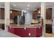 Open concept kitchen with sleek stainless steel appliances and views to the living room and outdoor patio at 6545 Muirfield Pt, Fairburn, GA 30213