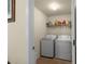 Well-lit laundry room features modern washer and dryer for convenient chores at 6545 Muirfield Pt, Fairburn, GA 30213