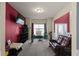 Comfortable living room with a leather sofa, media center and natural light streaming through the window at 6545 Muirfield Pt, Fairburn, GA 30213