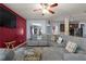 Spacious living room featuring a large sectional sofa, ceiling fan, and hardwood flooring at 6545 Muirfield Pt, Fairburn, GA 30213