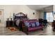 Bright main bedroom boasts wood floors, a sitting area, and a neutral color palette at 6545 Muirfield Pt, Fairburn, GA 30213