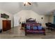 Bright main bedroom boasts wood floors, a sitting area, and a neutral color palette at 6545 Muirfield Pt, Fairburn, GA 30213