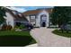 Stately home featuring manicured landscaping, a circular driveway, and a stone facade at 1146 Brookhaven Walk Way, Brookhaven, GA 30319