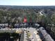 Aerial view of the community showcases tree lined streets, driveways and rooftops at 145 Sunset Ln, Woodstock, GA 30189