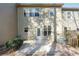 Rear view of home with back patio and small shrubs. Wood fence surrounds the small yard at 145 Sunset Ln, Woodstock, GA 30189